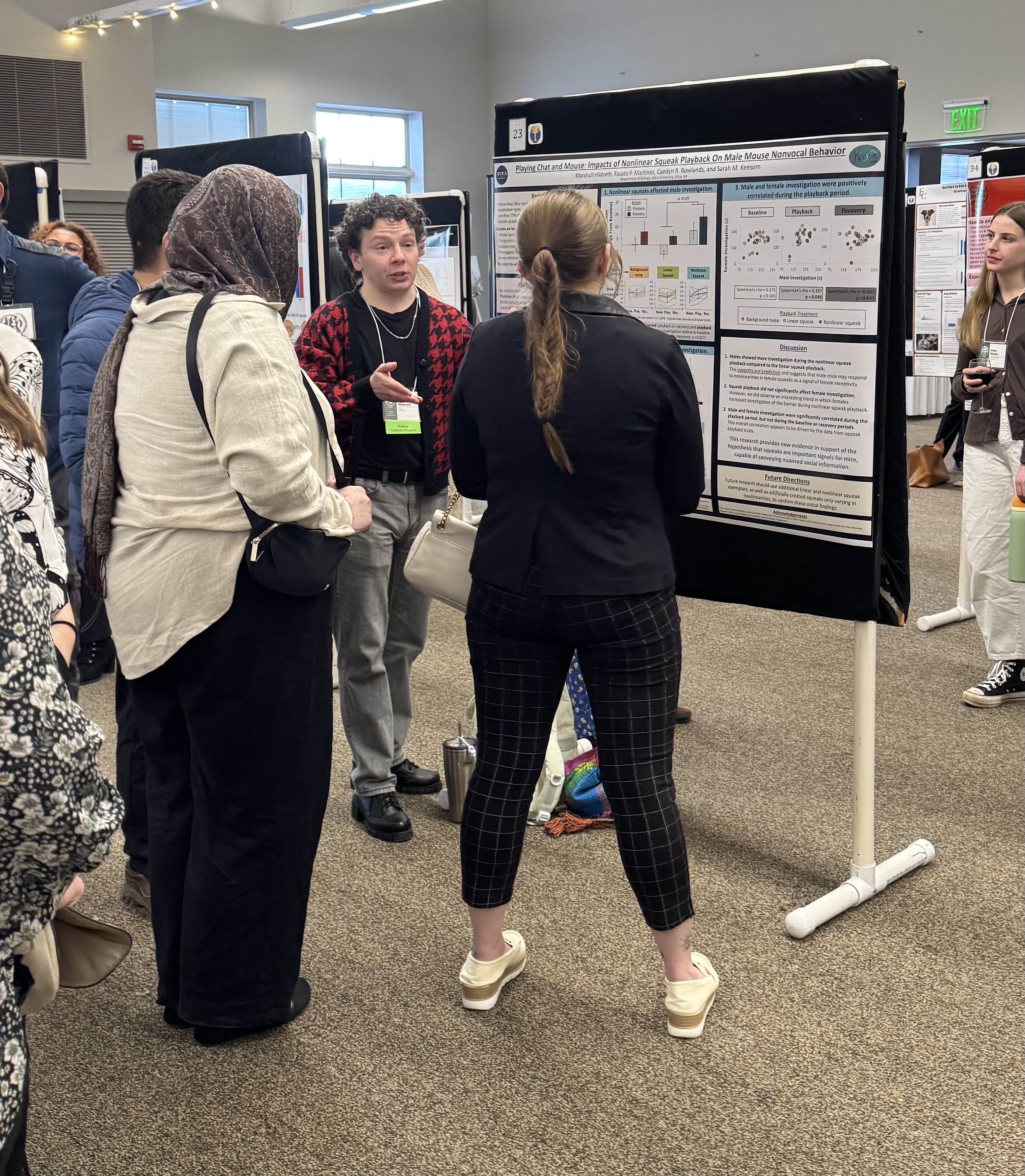 Standing next to a poster, Marshall Hildreth discusses research at the 33rd Annual Animal Behavior Conference.