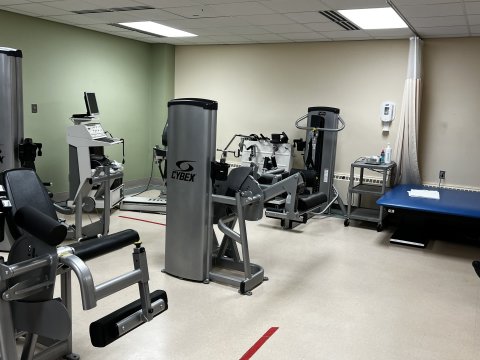 A room filled with gym equipment such as treadmills and stair machines used for orthapedic rehabilitation
