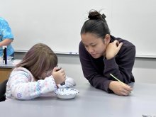 Elementary Student from Little Falls conducts experiement on field trip to Utica University.