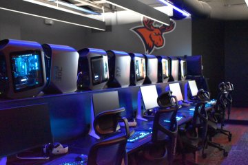 A row of seats and computers in the all-new eSports auditorium.