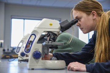 Gillian Bradley looks through microscope