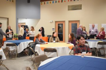 Wilcox Fellows sit at tables and mingle with President Todd Pfannestiel and members of the Wilcox Family during the 2024 Wilcox Fellows Reception.