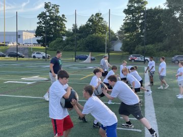 Players on the field as part of A Call to Men Football Camp.