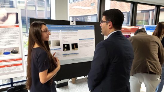Neilani Mulalic presenting her research to Dr. Ahmed Radwan