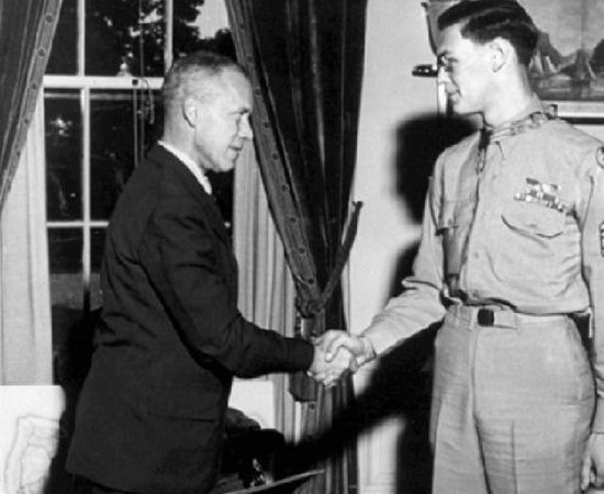 Black and white image of Forrest Vosler receving medal from President Franklin Delano Roosevelt.