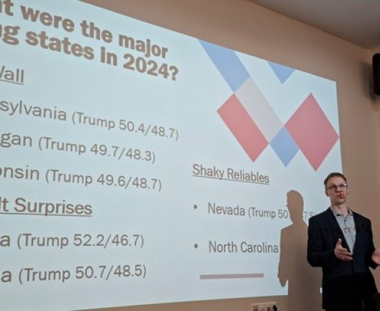 Professor Luke Perry lectures in front of a slide presentation at the University of Debrecen in Eastern Hungary.