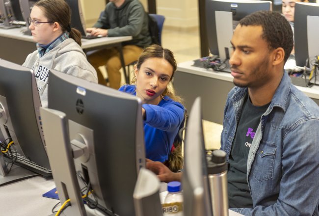 Business Student pointing to computer