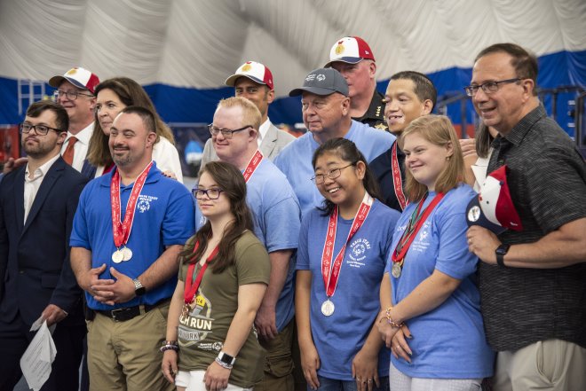 Members of the NYS Special Olympics pose with local politicians.