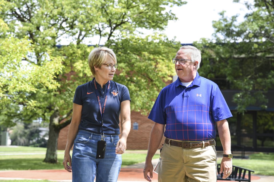 Laura Casamento and Todd Pfannestiel walk along the campus  in 2023