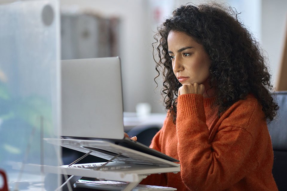 Woman researching options on her laptop