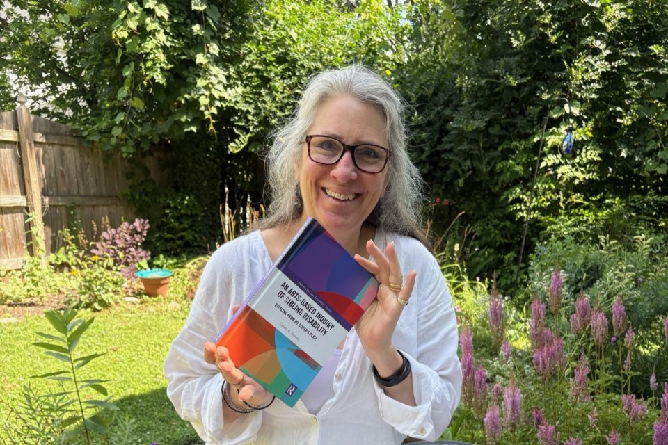 Linnea Franits with her book - An Arts-Based Inquiry of Sibling Disability: Stealing from My Sister’s Plate